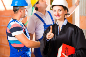 Reviewer or expert or lawyer and builder or worker with helmets controlling a construction or building site to report defect or fault or deficiency in a protocol